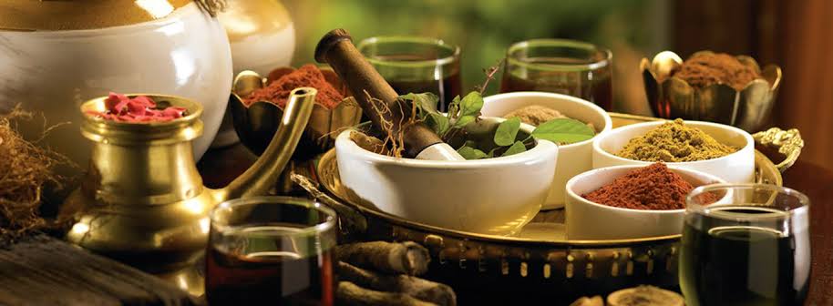 Ervas, especiarias e óleos com pilão e utensílios tradicionais de Ayurveda